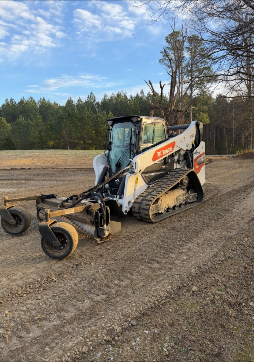 Bobcat tracked skid steer working on a residential yard for outdoor site preparation